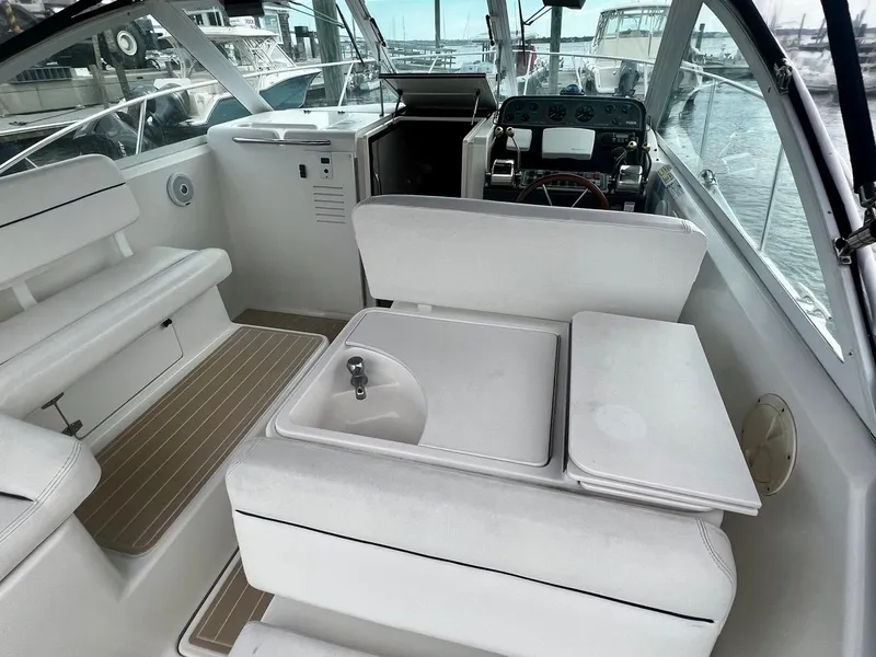 Slide: The Image of 2001 Tiara Yachts 2900 Coronet interior with seating and helm, docked at marina. - 16