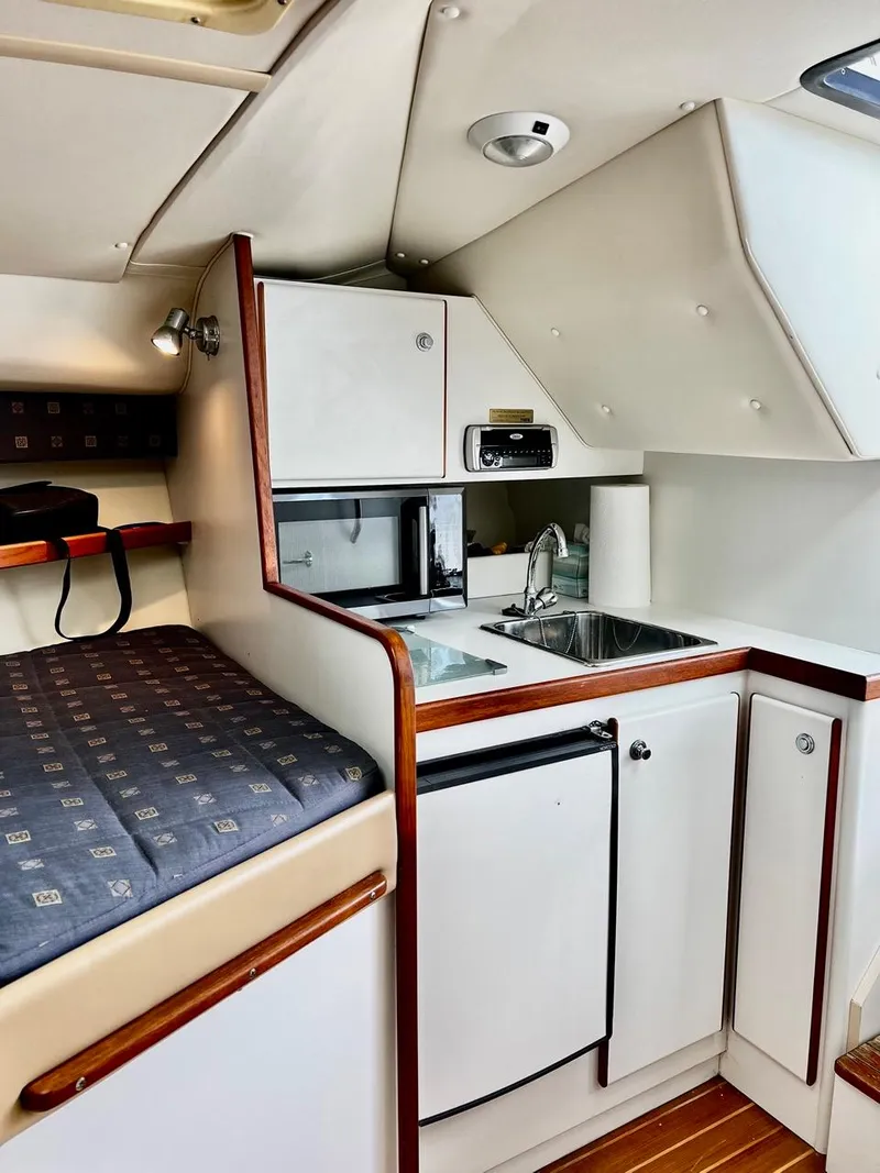 Slide: The Image of 2001 Tiara Yachts 2900 Coronet cabin interior with kitchenette and bed. - 18