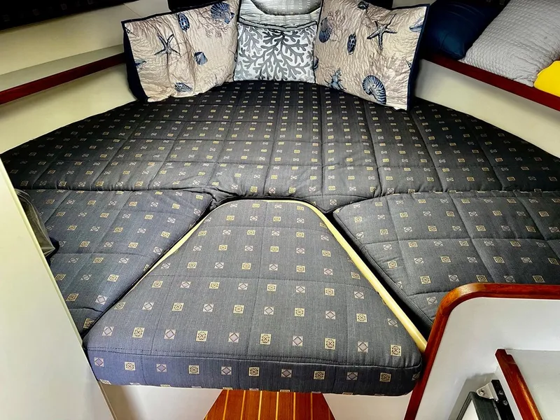 Slide: The Image of 2001 Tiara Yachts 2900 Coronet cabin with patterned bedding and decorative pillows. - 21