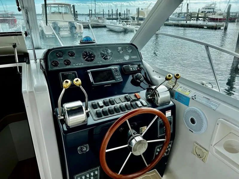 Slide: The Image of 2001 Tiara Yachts 2900 Coronet helm with controls and marina view. - 9