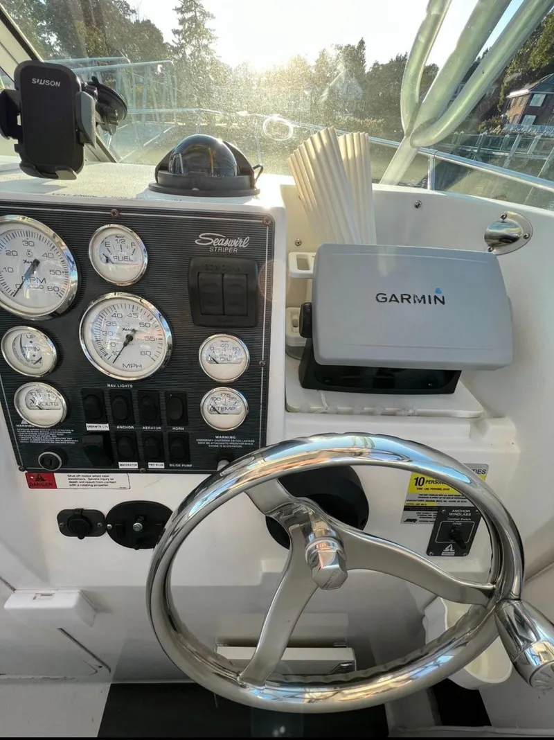 Slide: The Image of 2002 Seaswirl Striper 2601 Walkaround dashboard with Garmin navigation system and gauges. - 12