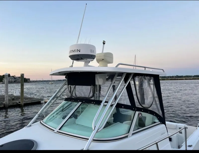 Slide: The Image of 2002 Seaswirl Striper 2601 Walkaround boat docked at sunset with Garmin radar. - 3
