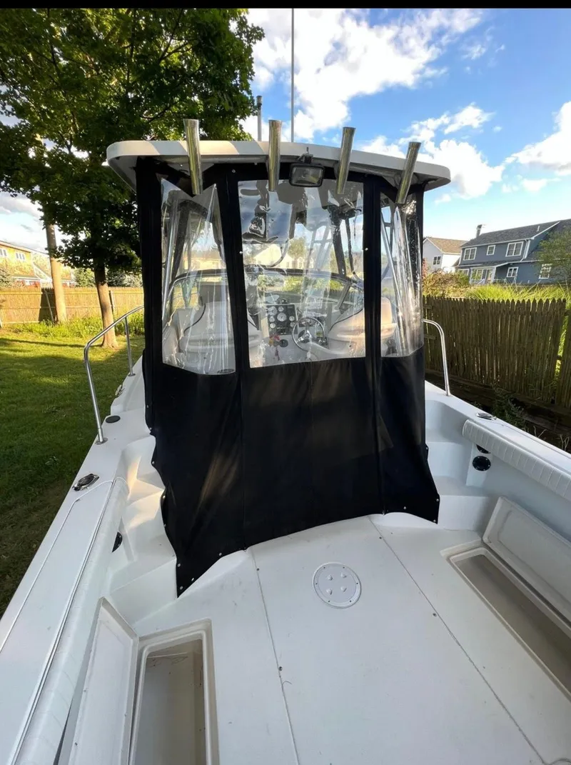 Slide: The Image of 2002 Seaswirl Striper 2601 Walkaround boat with covered cockpit, docked outdoors. - 5