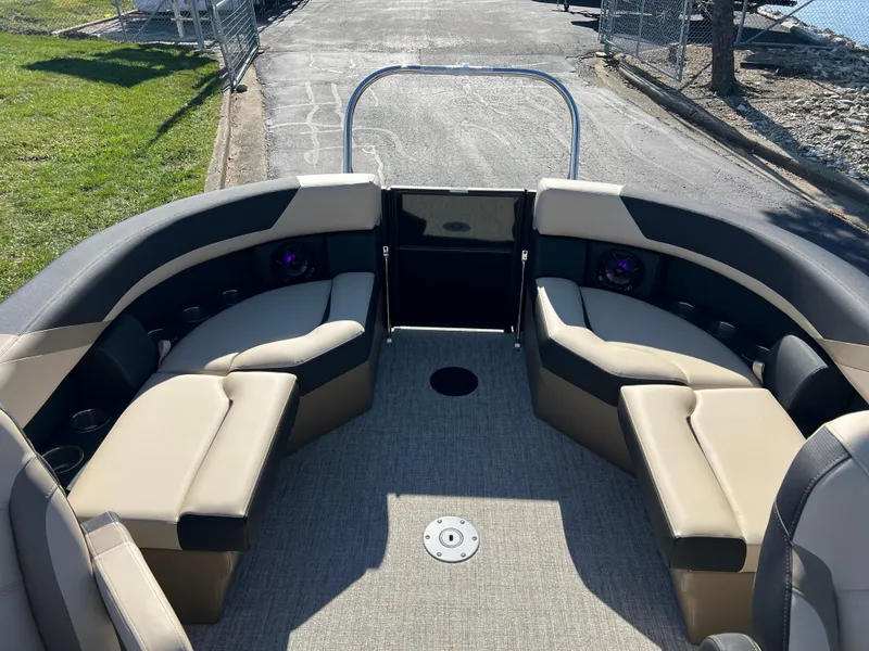 Slide: The Image of 2025 South Bay 220RS boat interior with beige and black seating. - 10