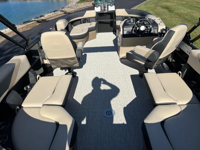 Slide: The Image of 2025 South Bay 220RS boat interior with beige seating and modern dashboard. - 15