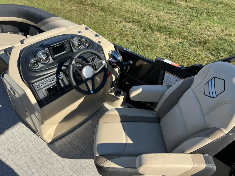 Slide: The Image of 2025 South Bay 220RS boat interior with steering console and captain's chair. - 16