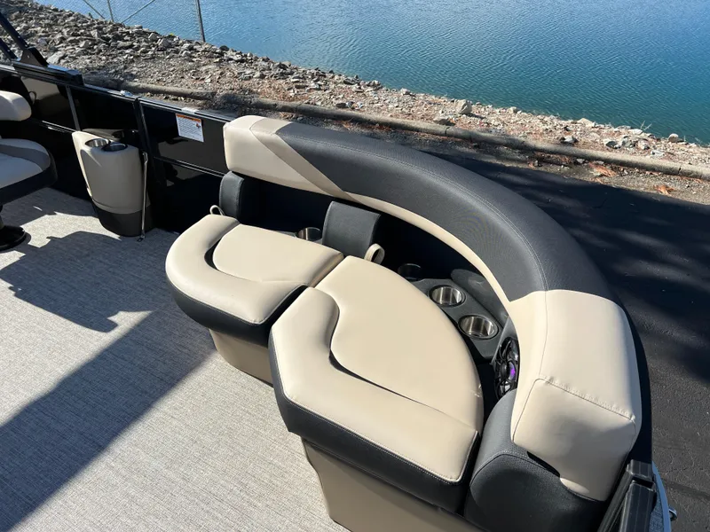 Slide: The Image of Luxurious seating on 2025 South Bay 220RS pontoon boat by the water. - 7