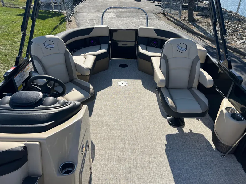 Slide: The Image of 2025 South Bay 220RS pontoon boat interior with beige seating and steering console. - 9