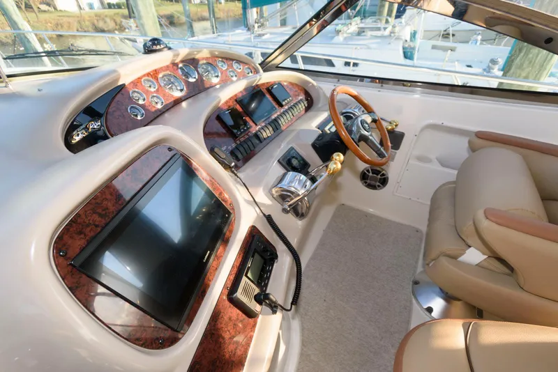 Slide: The Image of Interior cockpit of 2000 Sea Ray 380 Sundancer with modern controls and leather seating. - 10