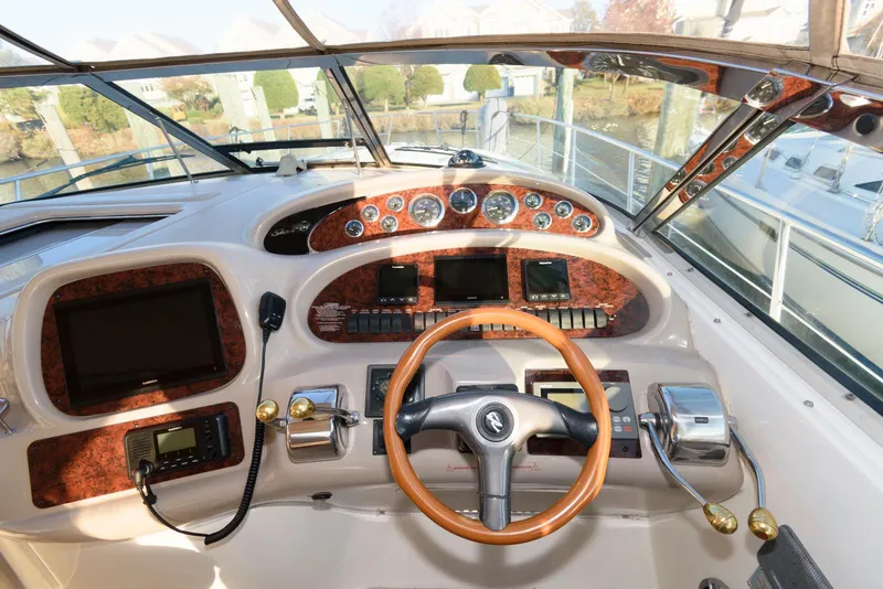 Slide: The Image of Cockpit of 2000 Sea Ray 380 Sundancer with wood accents and modern controls. - 11