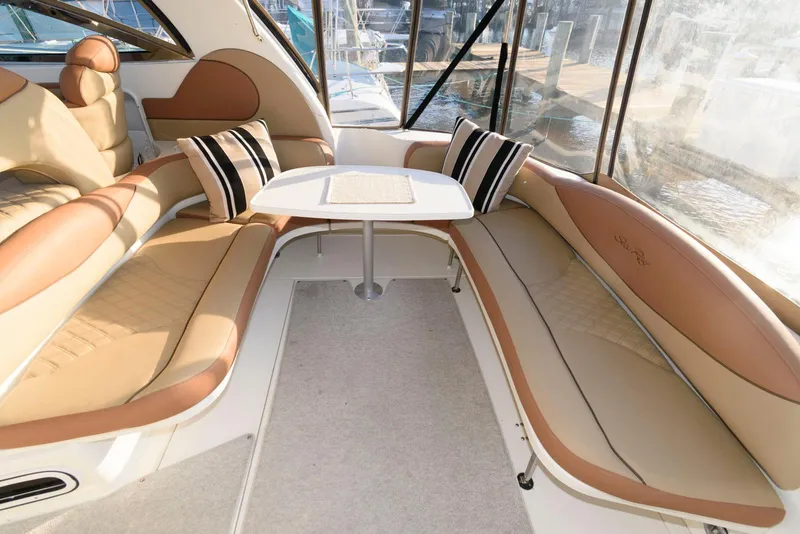 Slide: The Image of Luxurious interior of 2000 Sea Ray 380 Sundancer yacht with plush seating and table. - 13