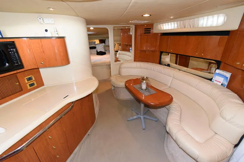 Slide: The Image of Luxurious interior of 2000 Sea Ray 380 Sundancer yacht with elegant seating and cabinetry. - 15