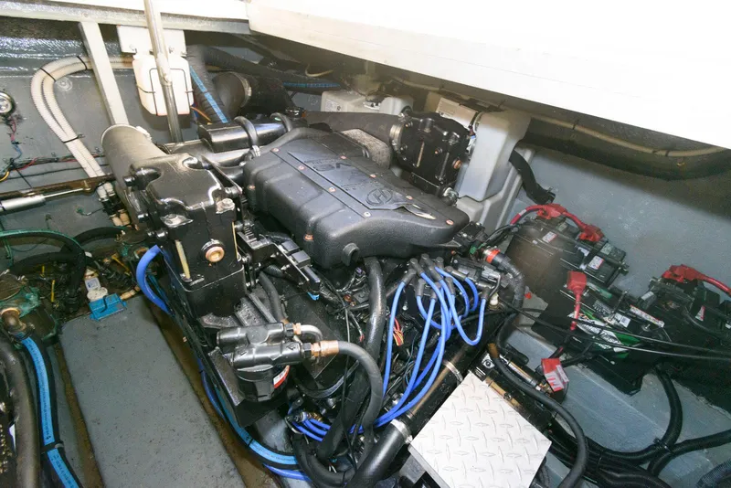 Slide: The Image of Engine compartment of 2000 Sea Ray 380 Sundancer with visible wiring and components. - 24