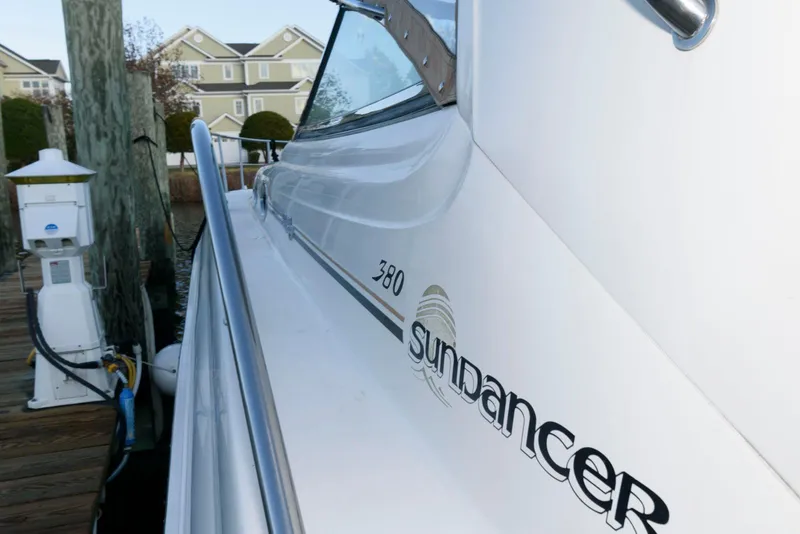 Slide: The Image of Sea Ray 380 Sundancer 2000 docked, showcasing sleek design and branding. - 5