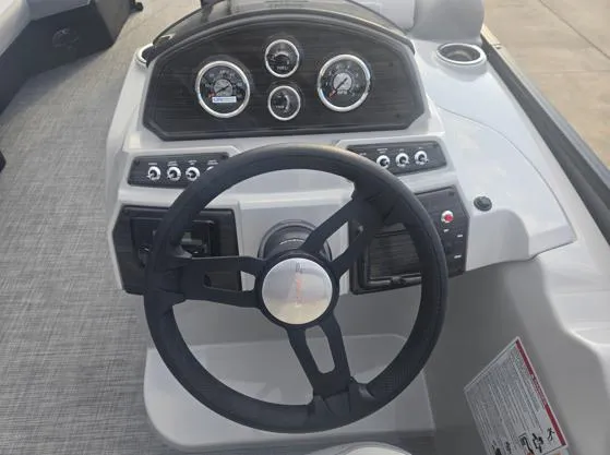 Slide: The Image of 2025 Lowe SS 230 WV boat dashboard with steering wheel and gauges. - 5