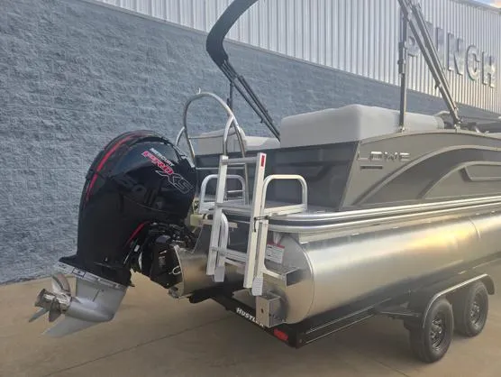 Slide: The Image of 2025 Lowe SS 230 WV pontoon boat with powerful outboard motor on trailer. - 9