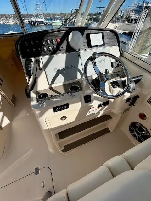 Slide: The Image of 2022 Grady-White Freedom 335 boat cockpit with Garmin navigation system. - 11