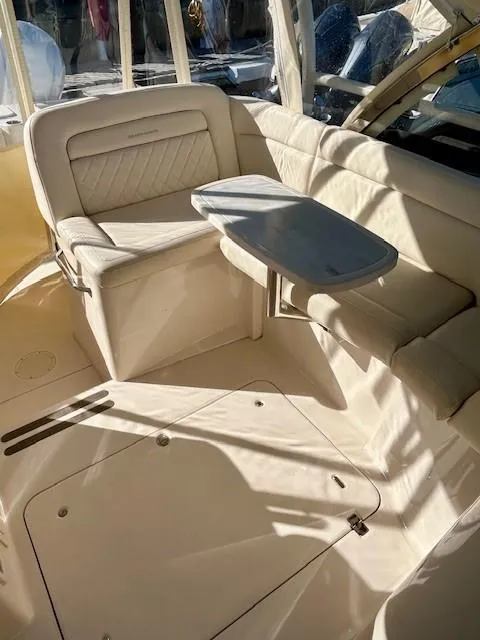 Slide: The Image of 2022 Grady-White Freedom 335 boat interior with seating and table. - 15