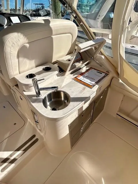 Slide: The Image of 2022 Grady-White Freedom 335 boat interior with sink and storage compartments. - 16