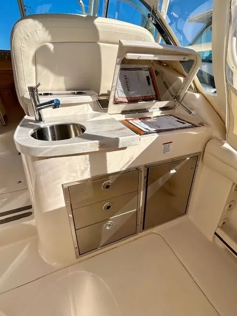 Slide: The Image of 2022 Grady-White Freedom 335 boat interior with sink and storage cabinets. - 17