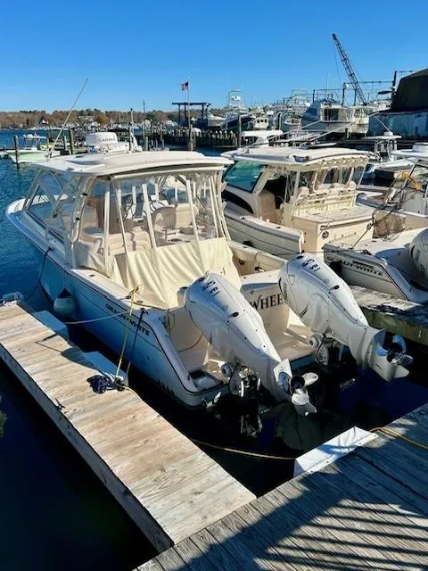 Slide: The Image of 2022 Grady-White Freedom 335 boat docked at marina with twin engines. - 2