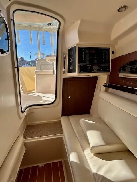 Slide: The Image of 2022 Grady-White Freedom 335 cabin interior with seating and control panel. - 21