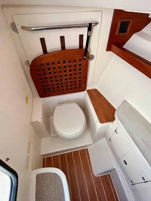Slide: The Image of 2022 Grady-White Freedom 335 boat bathroom with wooden accents and modern fixtures. - 23