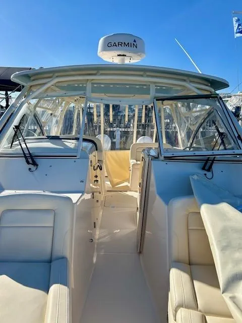 Slide: The Image of 2022 Grady-White Freedom 335 boat with Garmin equipment, spacious seating, and modern design. - 26