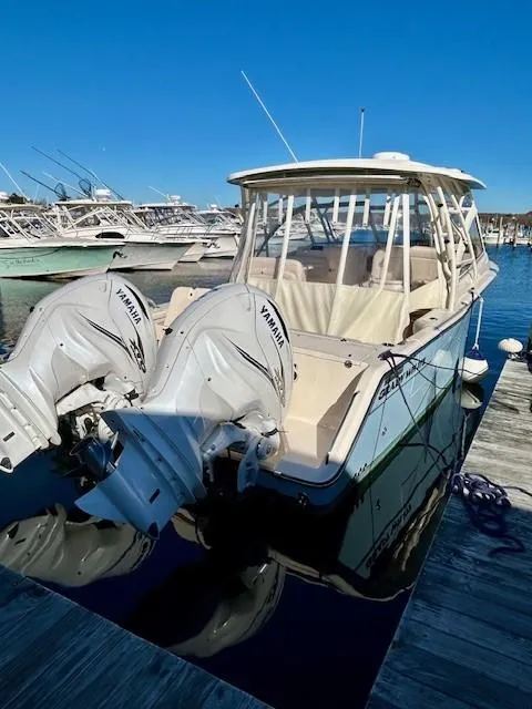 Slide: The Image of 2022 Grady-White Freedom 335 boat with twin Yamaha engines docked at marina. - 3