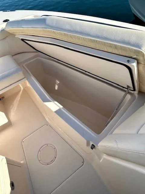 Slide: The Image of 2022 Grady-White Freedom 335 boat storage compartment, open, with cushioned seating. - 31