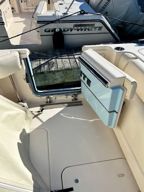Slide: The Image of 2022 Grady-White Freedom 335 boat interior with open door and seating area. - 37