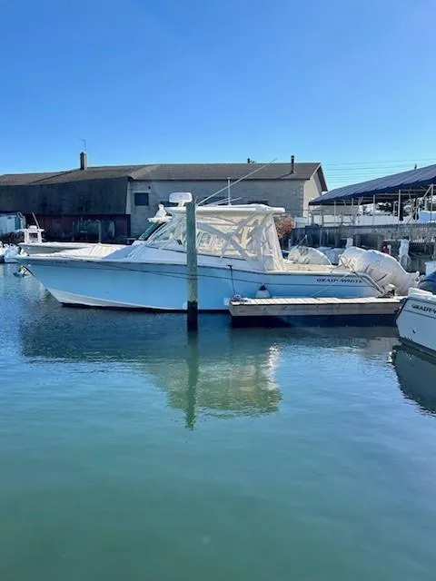 Slide: The Image of 2022 Grady-White Freedom 335 boat docked in a marina. - 4