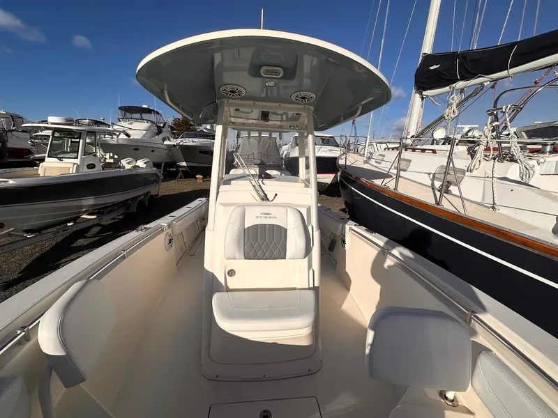 Slide: The Image of 2020 Cobia 262 Center Console boat docked among other vessels. - 10