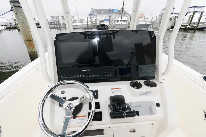 Slide: The Image of 2020 Cobia 262 Center Console boat dashboard with steering wheel and navigation controls. - 15