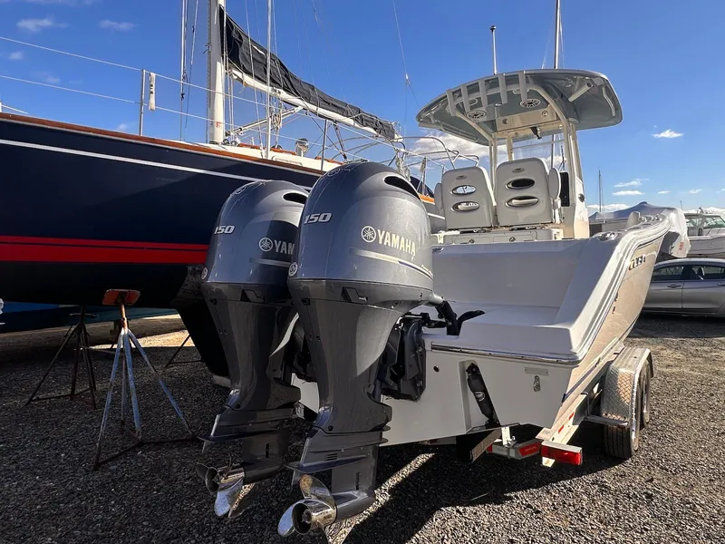 Slide: The Image of 2020 Cobia 262 Center Console boat with twin Yamaha 150 engines on trailer. - 25