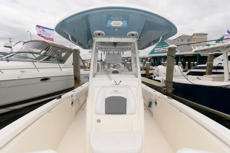 Slide: The Image of 2020 Cobia 262 Center Console boat docked at marina, showcasing spacious deck and seating. - 5