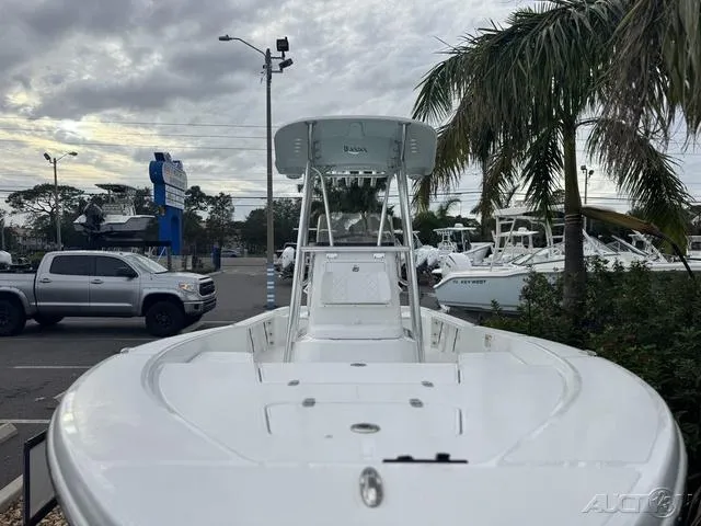 Slide: The Image of 2025 BlackJack 224 boat in a marina, surrounded by palm trees and parked vehicles. - 11