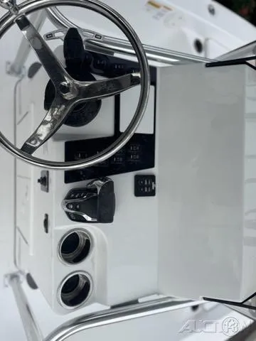 Slide: The Image of 2025 BlackJack 224 boat dashboard with steering wheel and controls. - 22