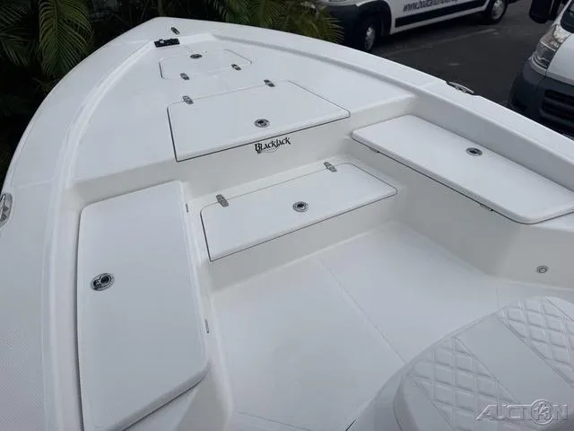 Slide: The Image of 2025 BlackJack 224 boat deck with storage compartments and seating. - 25