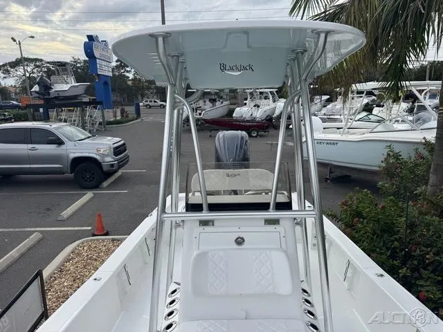 Slide: The Image of BlackJack 224 boat, 2025 model, parked in a marina with other boats and vehicles. - 28