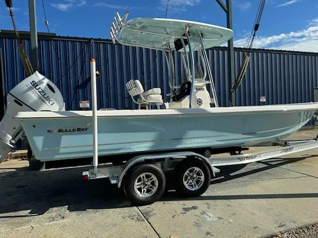 The Image of 2025 Bulls Bay 2400 boat on trailer with Suzuki engine, parked outdoors. - 0