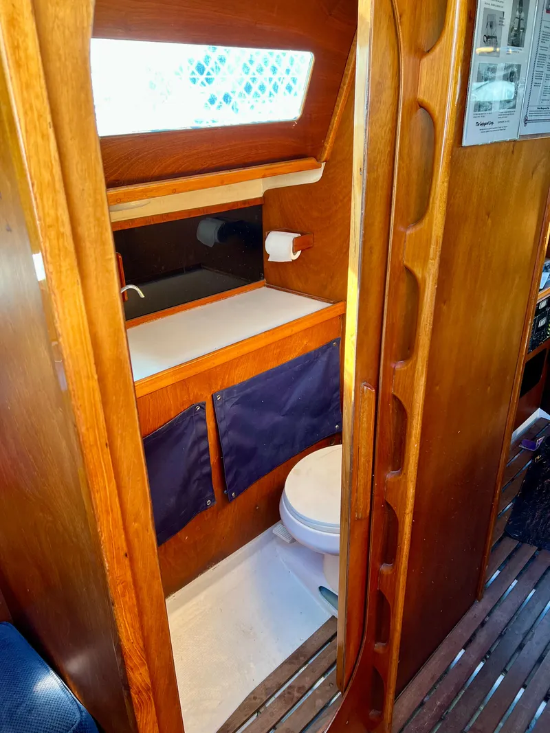 Slide: The Image of 1985 Santa Cruz 50 yacht bathroom with wooden interior and compact design. - 13