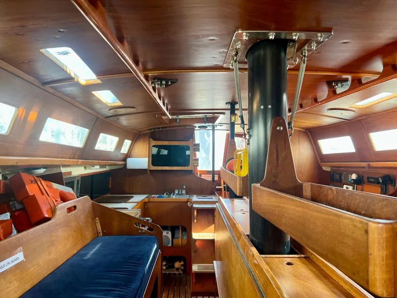 Slide: The Image of Interior of a 1985 Santa Cruz 50 sailboat, featuring wooden finishes and seating. - 20
