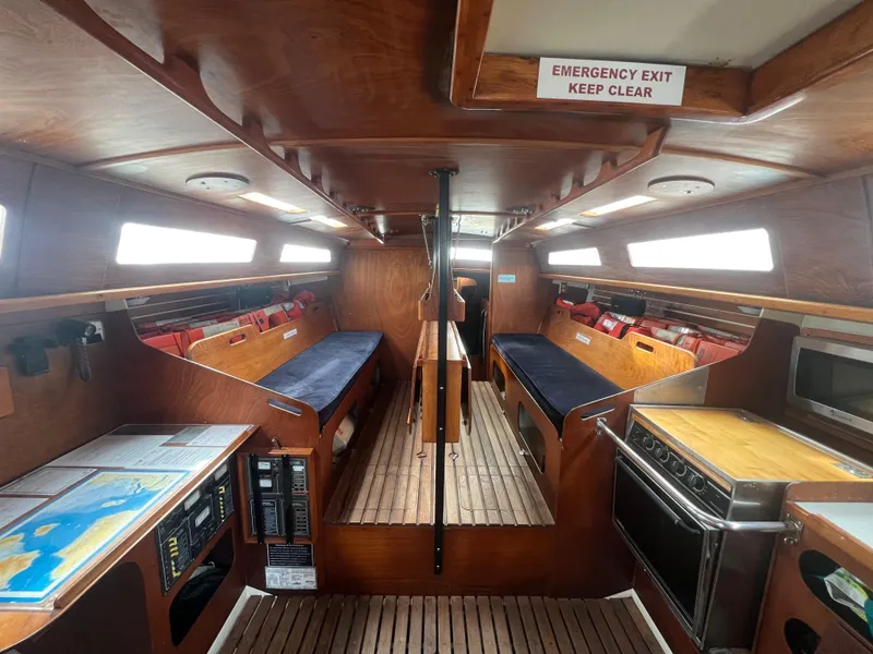 Slide: The Image of Interior of 1985 Santa Cruz 50 sailboat with wooden finish and navigation equipment. - 24