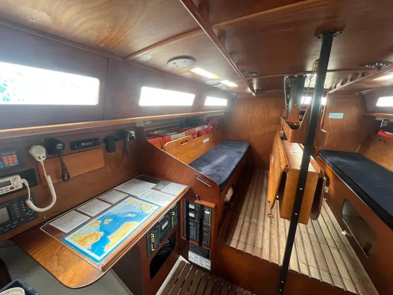 Slide: The Image of Interior of a 1985 Santa Cruz 50 sailboat with wooden finishes and navigation equipment. - 26