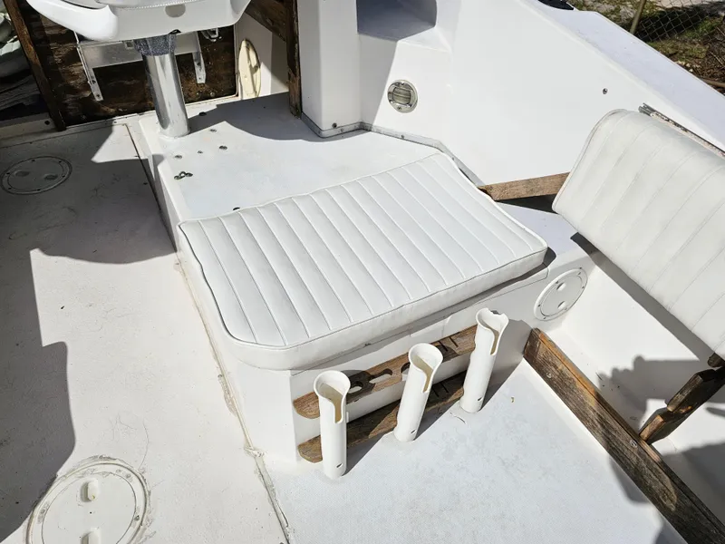 Slide: The Image of 1985 Grady-White 228 Seafarer boat interior with white seating and rod holders. - 14