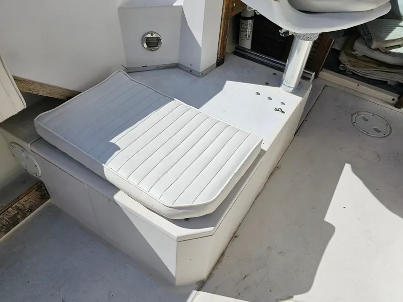 Slide: The Image of 1985 Grady-White 228 Seafarer boat interior with white cushioned seating. - 15