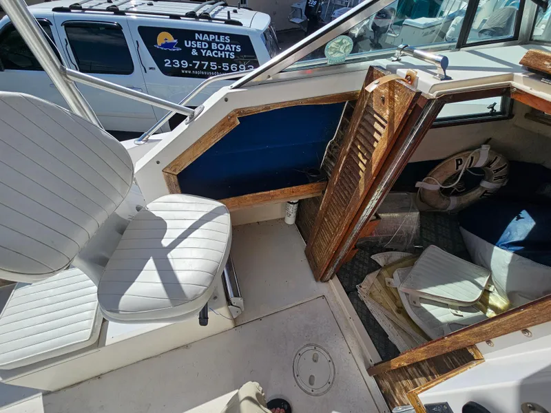 Slide: The Image of 1985 Grady-White 228 Seafarer boat interior with seating and cabin view. - 18