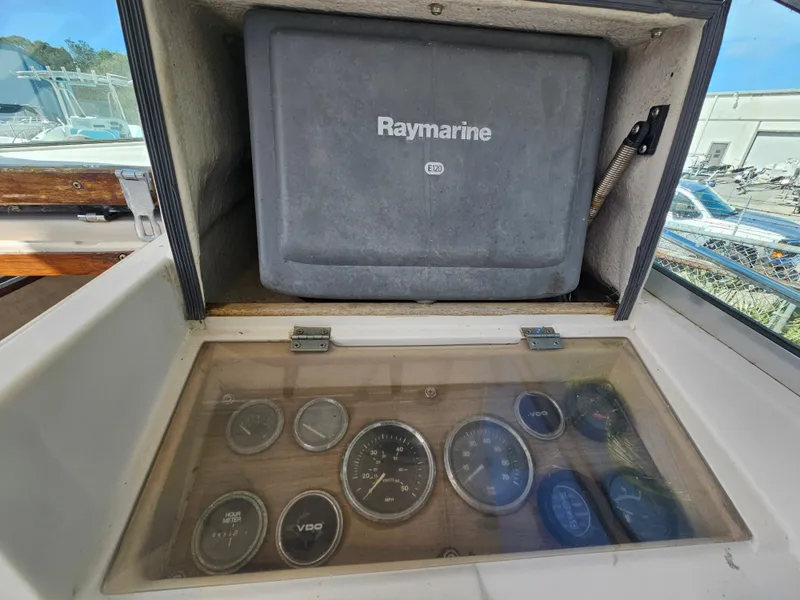 Slide: The Image of 1985 Grady-White 228 Seafarer dashboard with Raymarine equipment and gauges. - 20