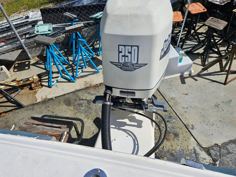 Slide: The Image of 1985 Grady-White 228 SEAFARER boat with 250 horsepower outboard motor in a yard. - 27